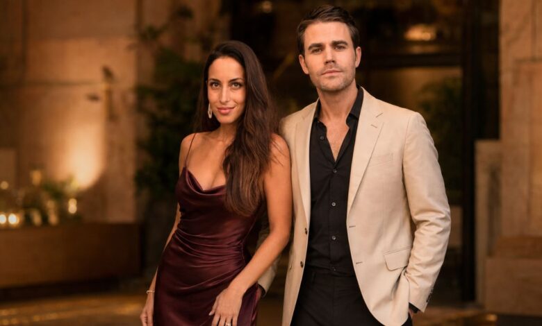 Formally dressed couple posing together at an elegant evening event