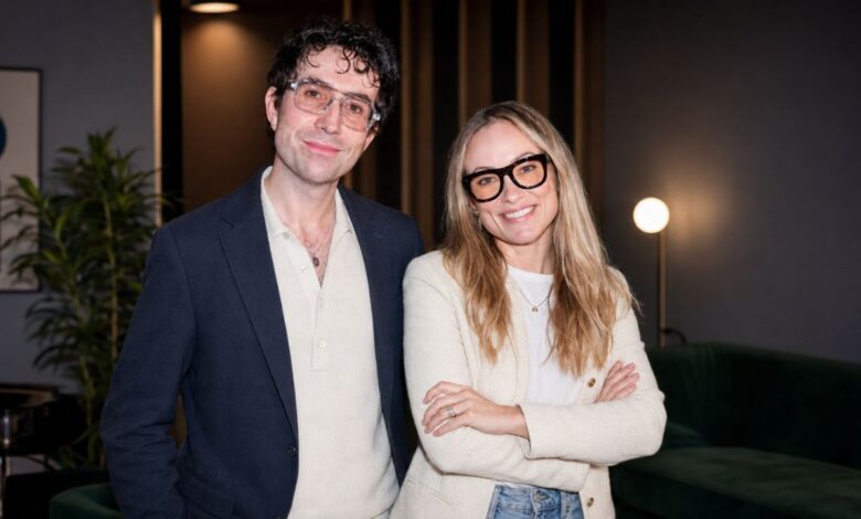 A man and woman posing together indoors for an editorial photograph