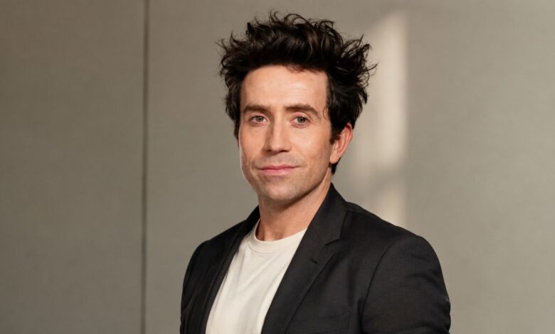 Nick Grimshaw wearing a black blazer for a studio portrait