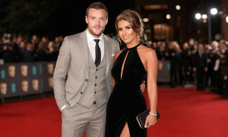Rebekah Vardy and Jamie Vardy posing together on a red carpet at an evening awards event