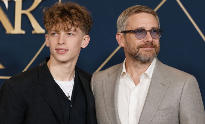 English actor Joe Freeman standing next to his father, Martin Freeman, at a formal industry event.