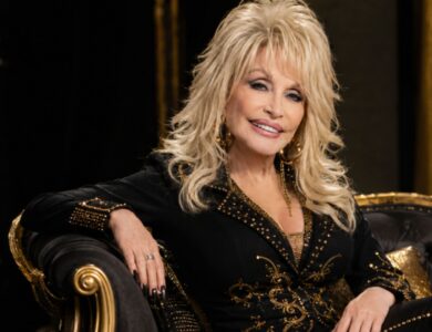 Dolly Parton portrait in black and gold outfit representing her $450 million net worth and music legacy