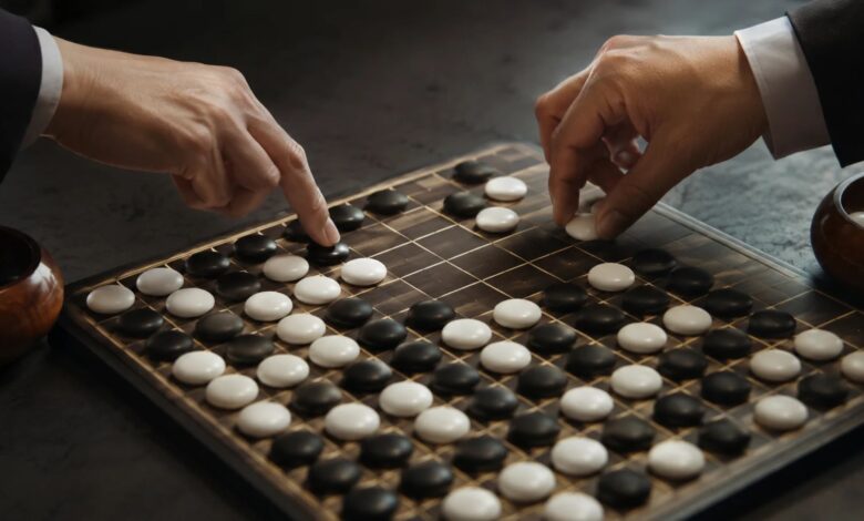 Two players making strategic final moves on a nearly completed grid game board