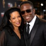 Mitzie Lau and Michael Wright smiling together at a red carpet event