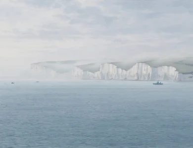 White cliffs of Dover across calm Channel waters at dawn with a distant boat on the water